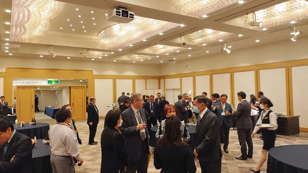 A group of people having a standing up dinner during the 48th ASEAN-Japan business meeting in Tokyo